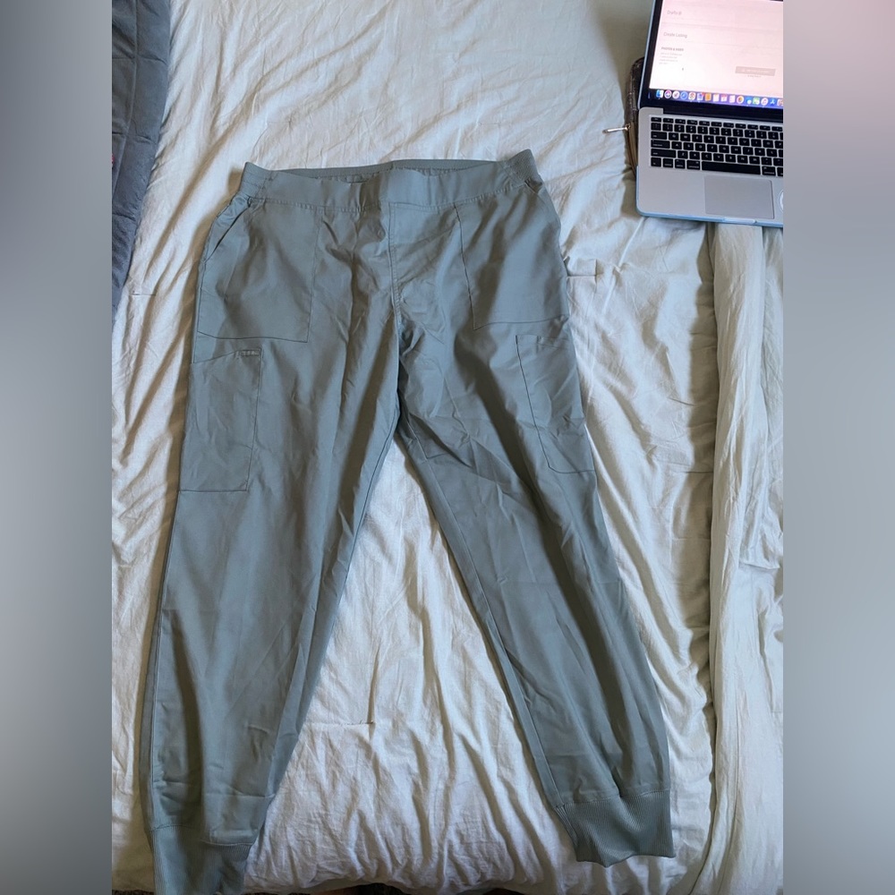 Scrub pants, has an adjustable waist string on inside, many pockets and pen slot